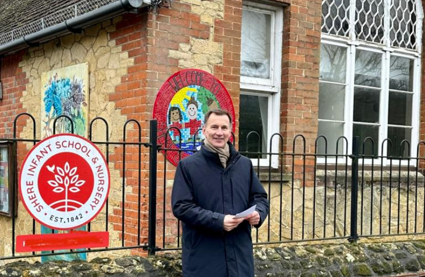 Jeremy Hunt MP in front of the school where he learnt to read in Shere. 